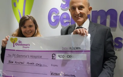 Howard Cohen presenting a cheque to St Gemmas for Make A Will Month