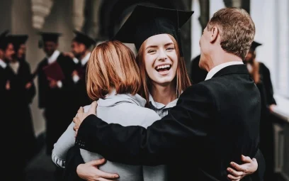 female student hugging parents at graduation