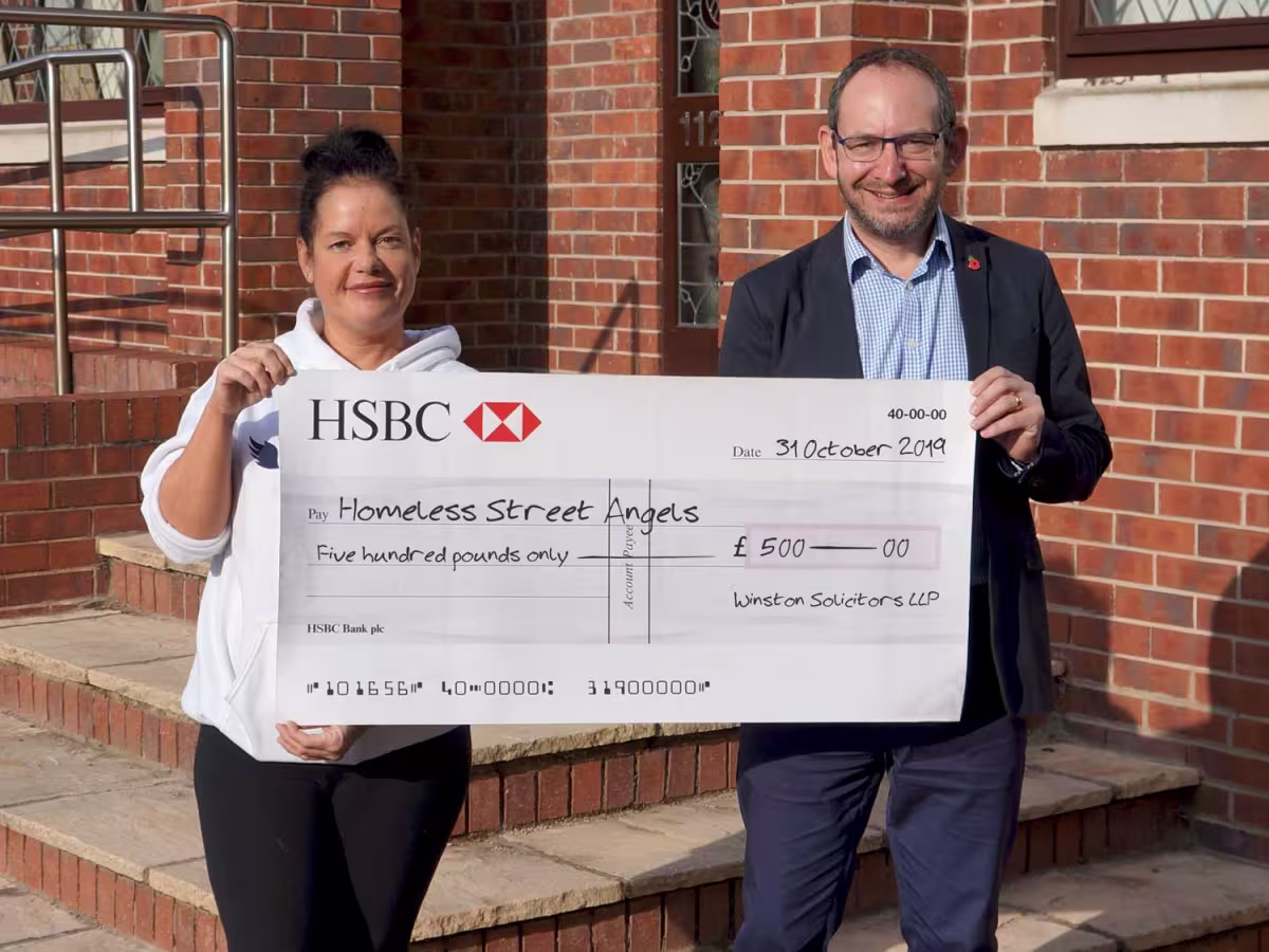 Becky from Homeless Street Angels receives a donation from Winston Solicitors in Roundhay, Leeds