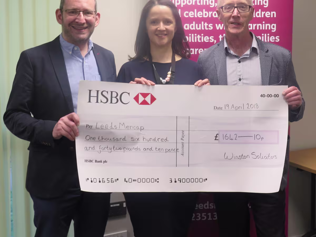 Winston Solicitors presenting charity cheque to Leeds Mencap
