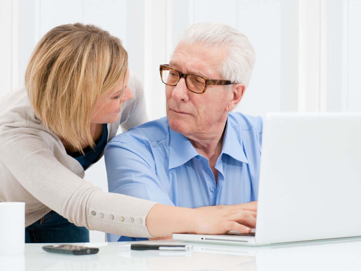 female helping mature male to use a computer female helping mature male to use a computer