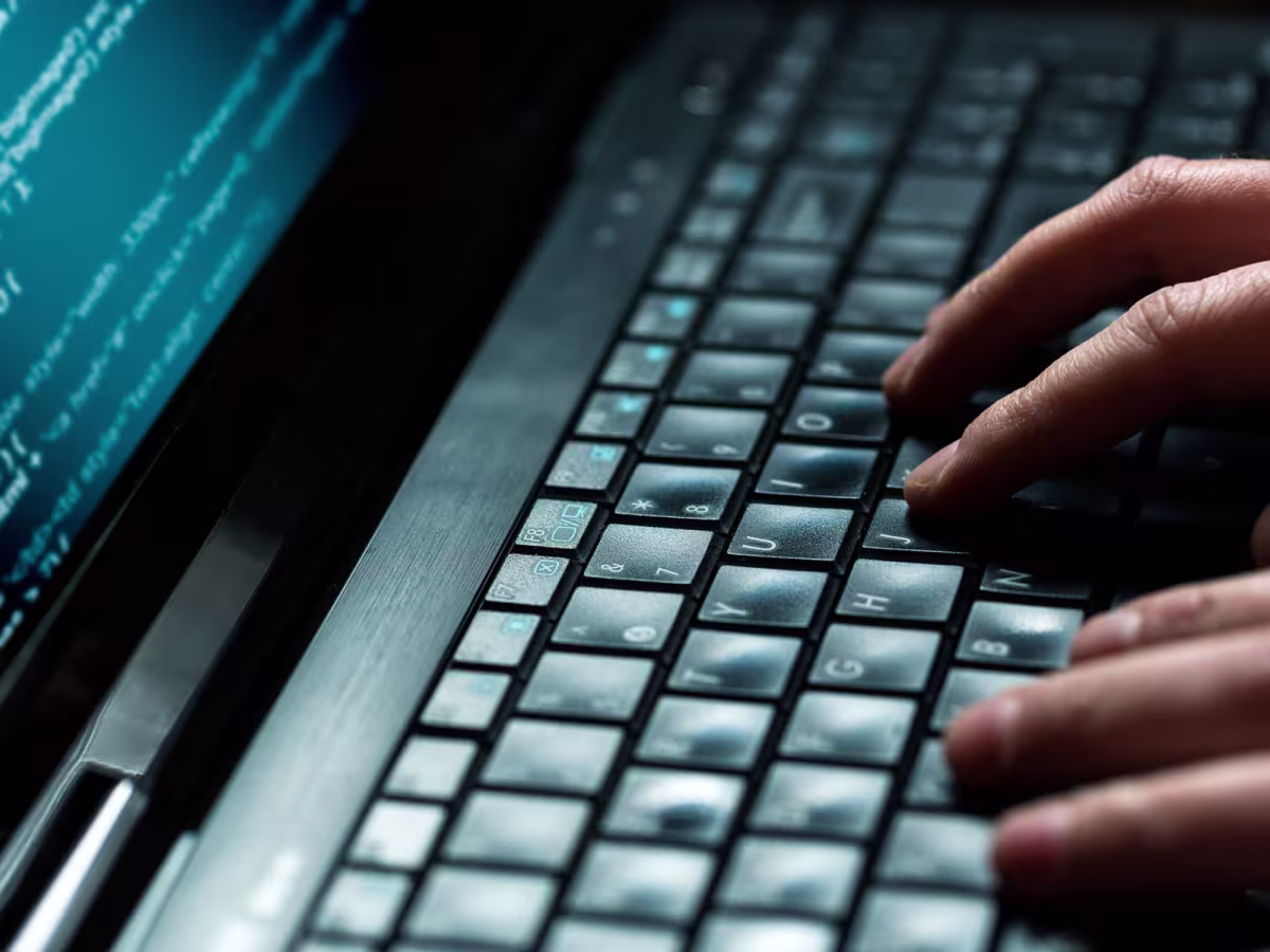 hands typing on a computer keyboard