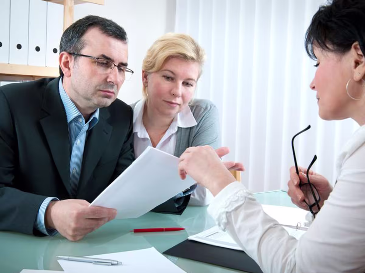 dispute resolution three people looking at document