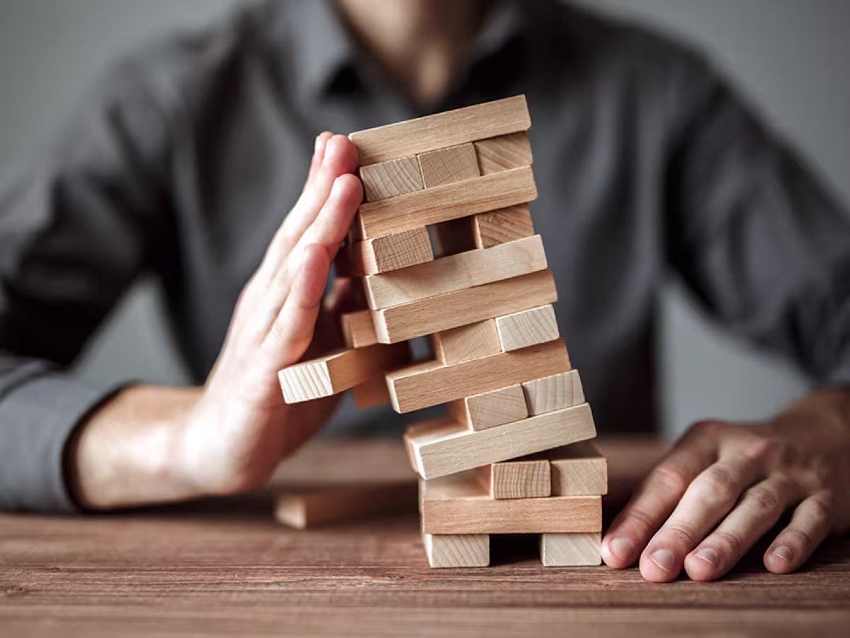 hand stopping tumbling blocks
