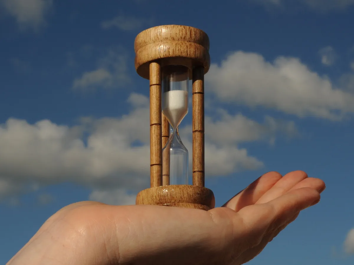 The time is in your hands to make your Lasting Power of Attorney egg timer in person's hand representative of time running out