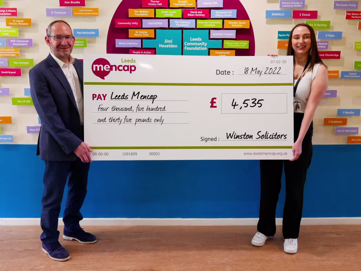 Jonathan Winston presents a fundraising cheque to Leeds Mencap