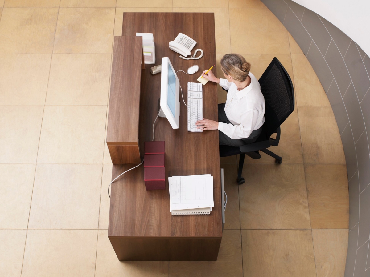 Can voluntary redundancy also amount to unfair dismissal? Receptionist at desk - voluntary redundancy can lead to unfair dismissal
