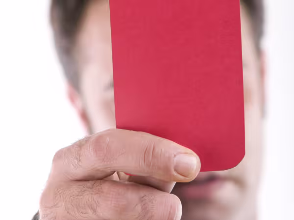Referee holds up red card in Mourinho sacking case
