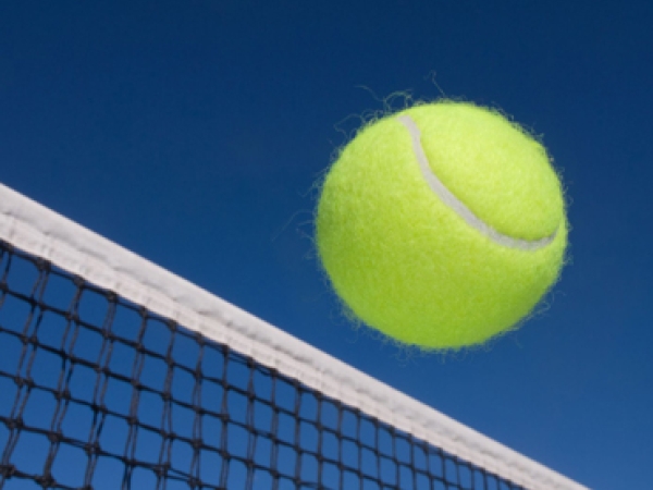 Tennis ball clearing the net