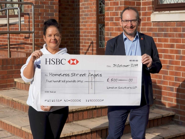 Becky from Homeless Street Angels receives a donation from Winston Solicitors in Roundhay, Leeds