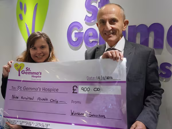 Howard Cohen presenting a cheque to St Gemmas for Make A Will Month