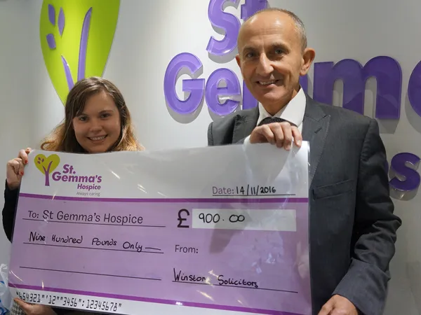 Howard Cohen presenting a cheque to St Gemmas for Make A Will Month