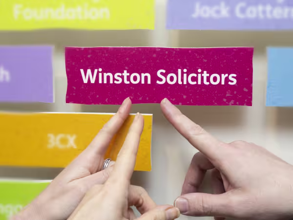 Leeds Mencap presented Winston Solicitors with their supporters brick