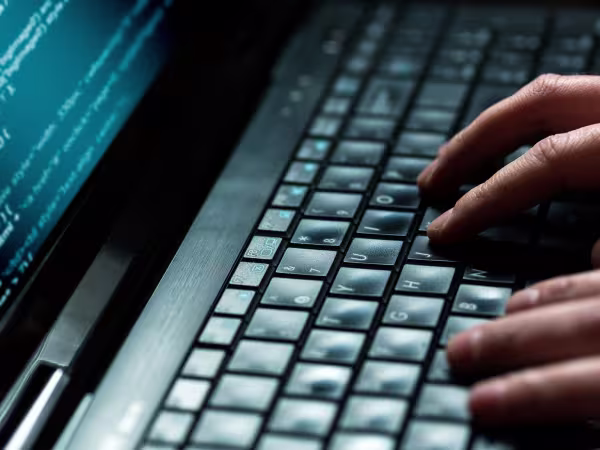 hands typing on a computer keyboard
