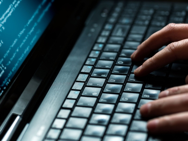 hands typing on a computer keyboard