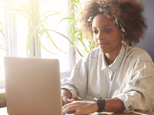 female sat at laptop working