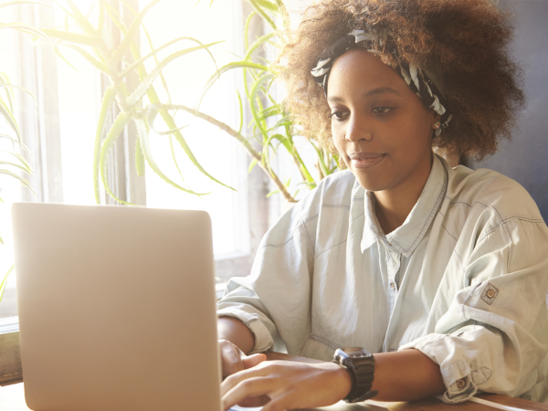 female sat at laptop working